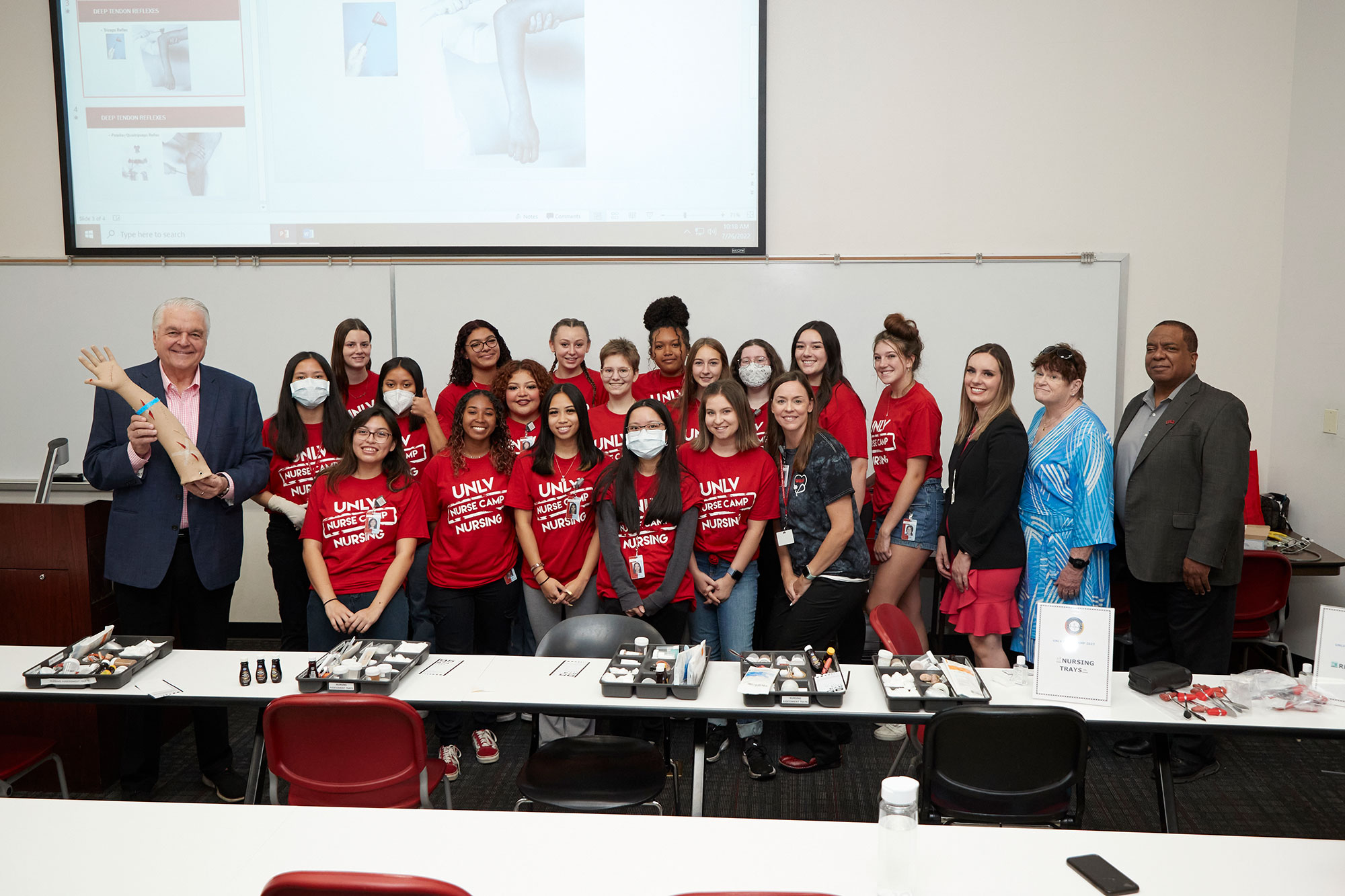 A group of students in red scrubs