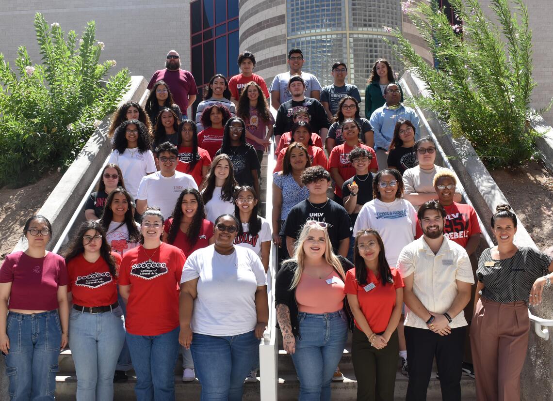 Peer mentors pose for a group photo on some steps