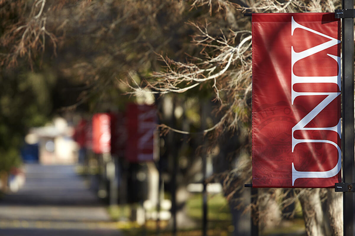 Red U-N-L-V banner hanging from a light post