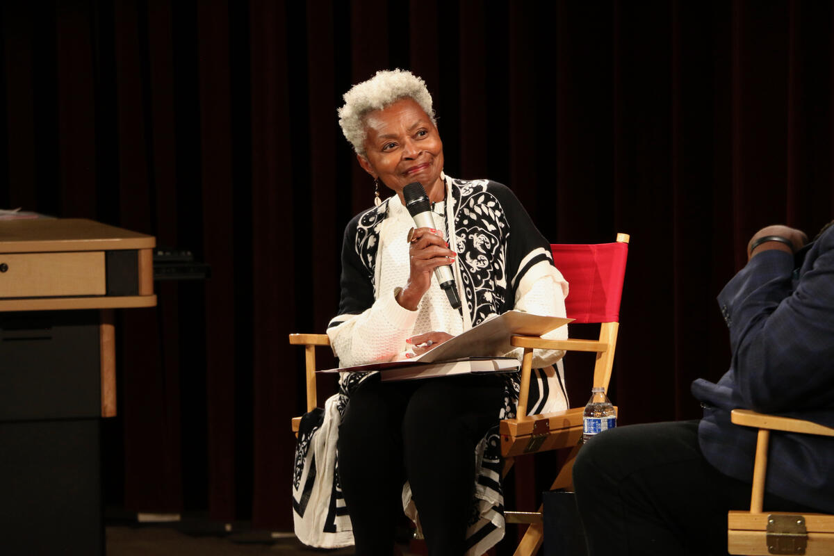 Claytee White seated on stage with microphone