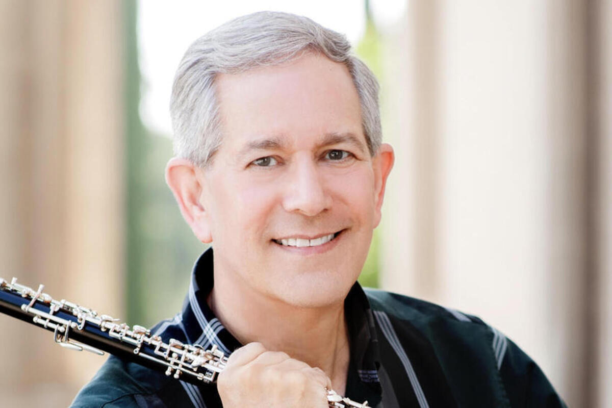 close up of Stephen Caplan holding an instrument