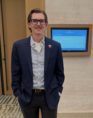 Carson Keller wearing a blue suit jacket