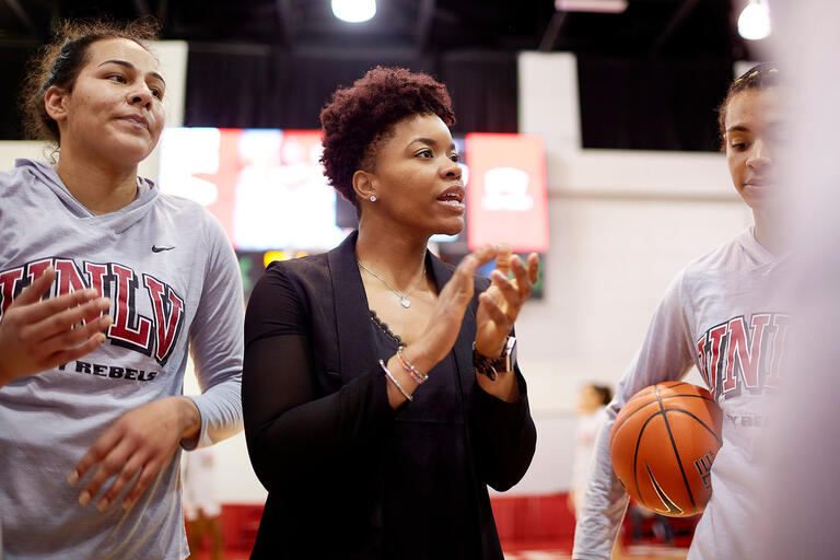 Mia Bell coaching players before game.
