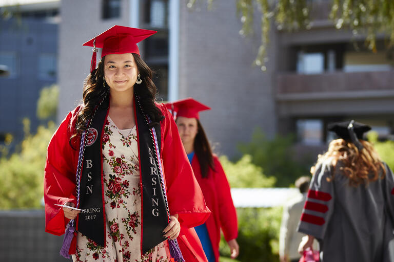 A student wearing a graduation cap and gown