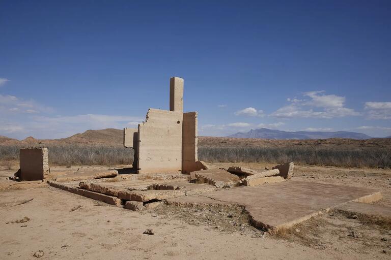 sandstone colored structure against a clear blue sky