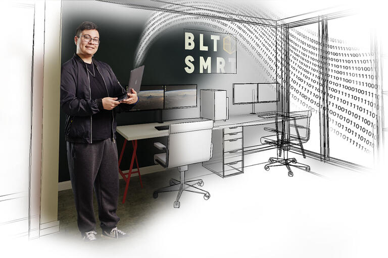 Marcos Kano holding a laptop while standing inside an illustration of a room with a work desk