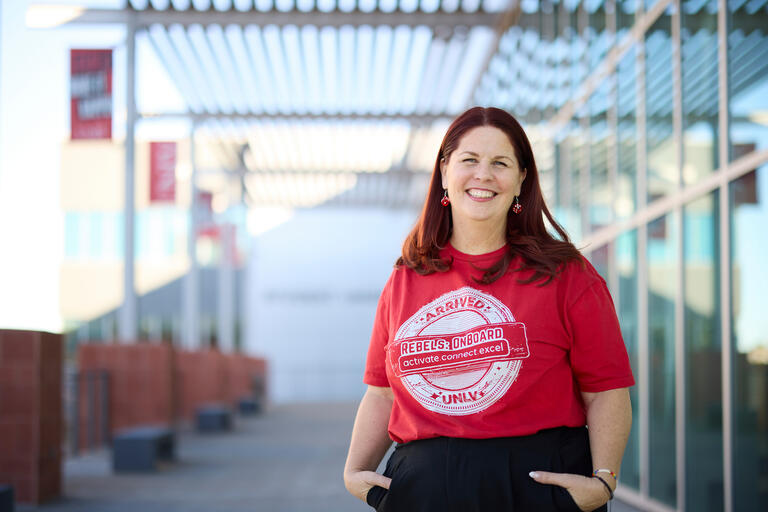 woman with dark hair wears red shirt that reads &quot;Rebel Onboard&quot;