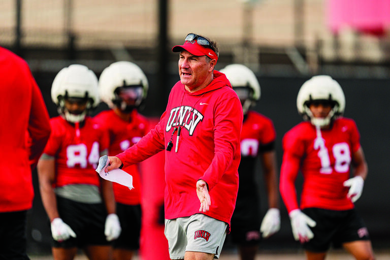 football coach at practice with athletes