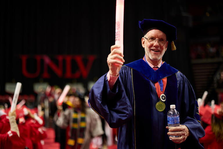 man in regalia at commencement ceremony