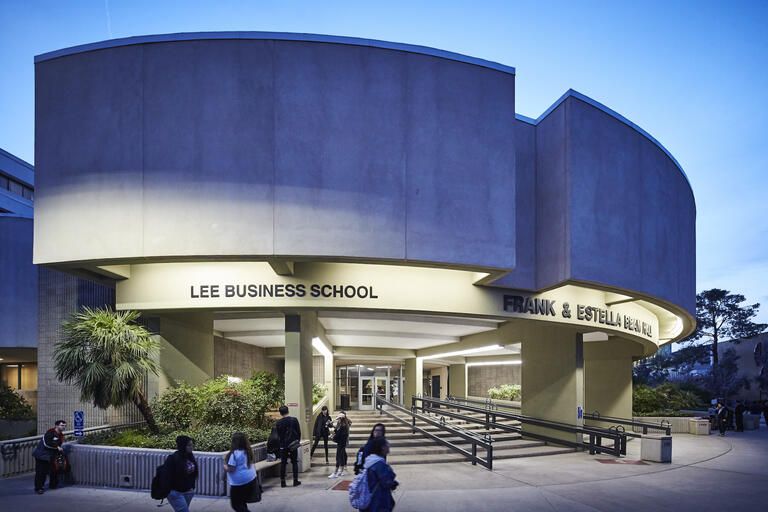 exterior of Beam Hall with Lee Business School on building