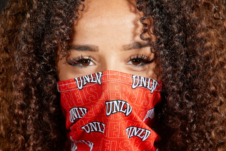 Woman wearing a U.N.L.V. mask